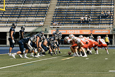 How do Football Coaches Communicate with Their Quarterbacks on the Field?